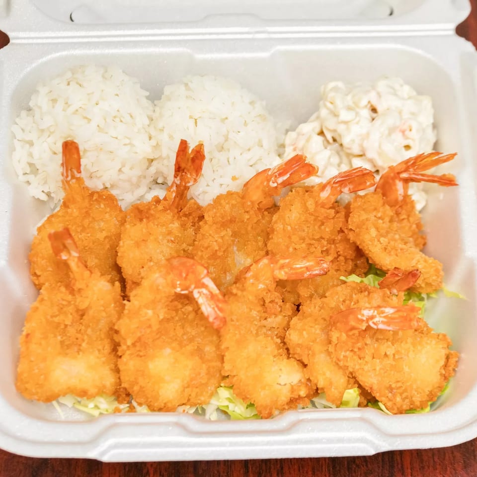 F's Hawaiian Food's fried shrimp plate with rice and macaroni salad in a takeout container.